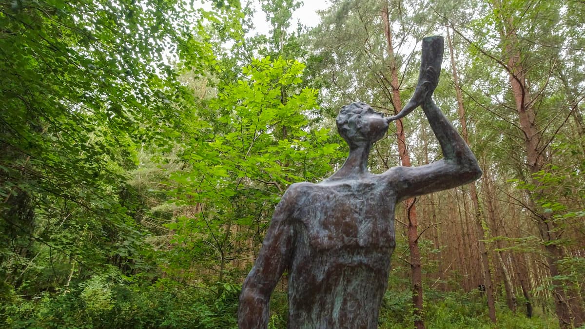 Outdoor sculptures along a forest trail